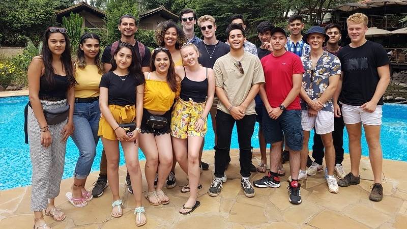 the summer 2018 volunteers pose in front of the swimming at Wildebeest Eco Camp in Nairobi